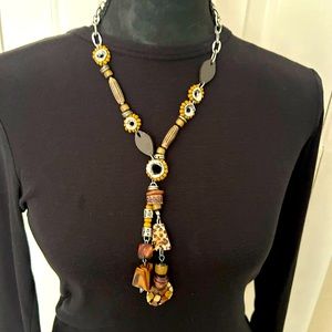 Stunning earth tone necklace. 15” hang and adjustable. Will dazzle any outfit!